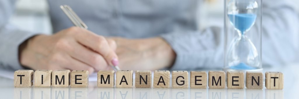 Close-up of time management words collected with wooden cubes. Work time planning, overtime deadline and delegation of authority concept